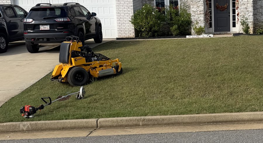 Mower and trimmer on a finished front lawn